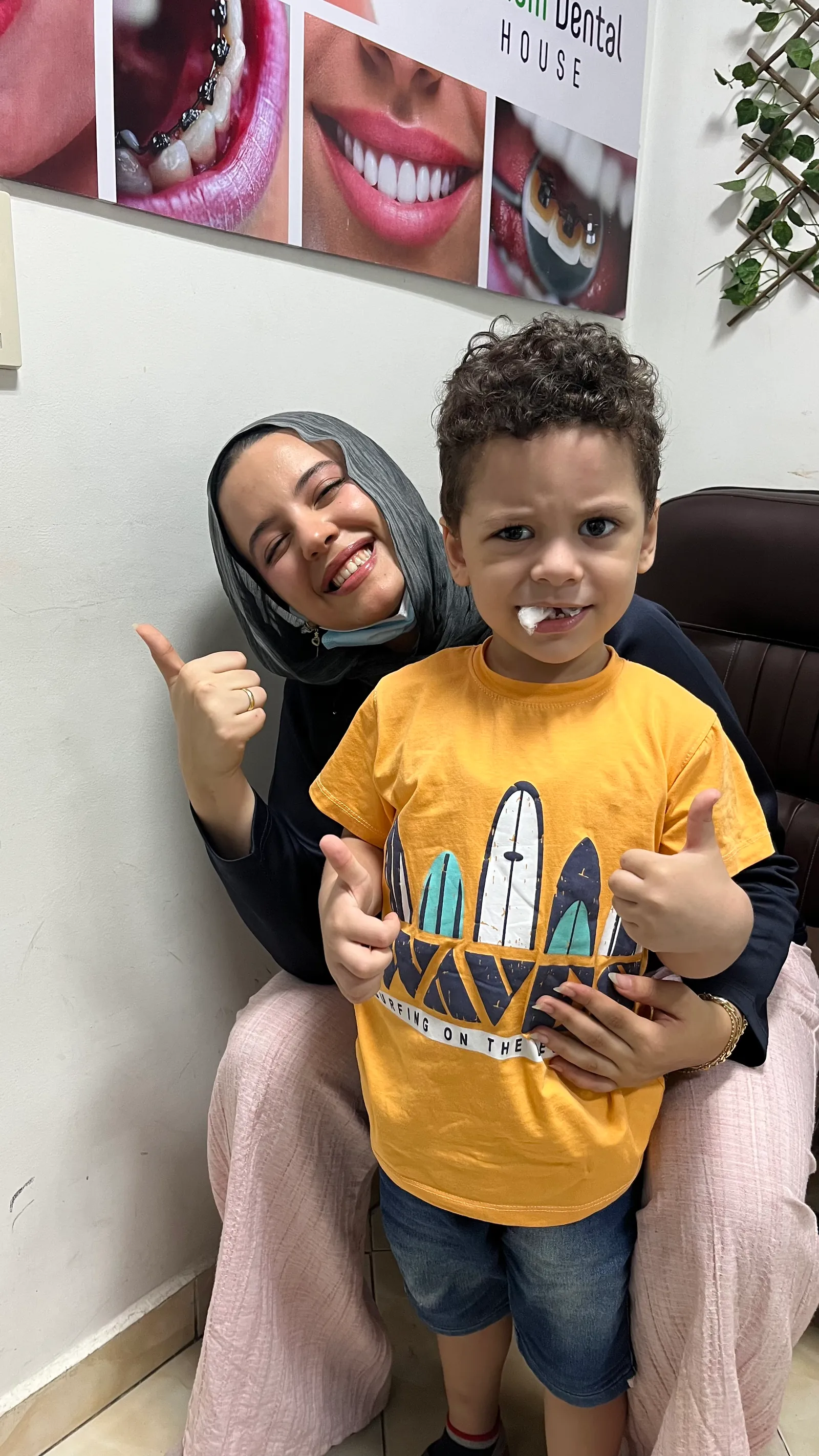 A boy giving a thumbs-up with Dr. Haneen